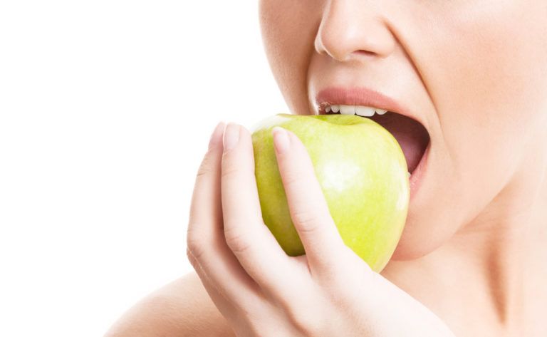 Female eating apple