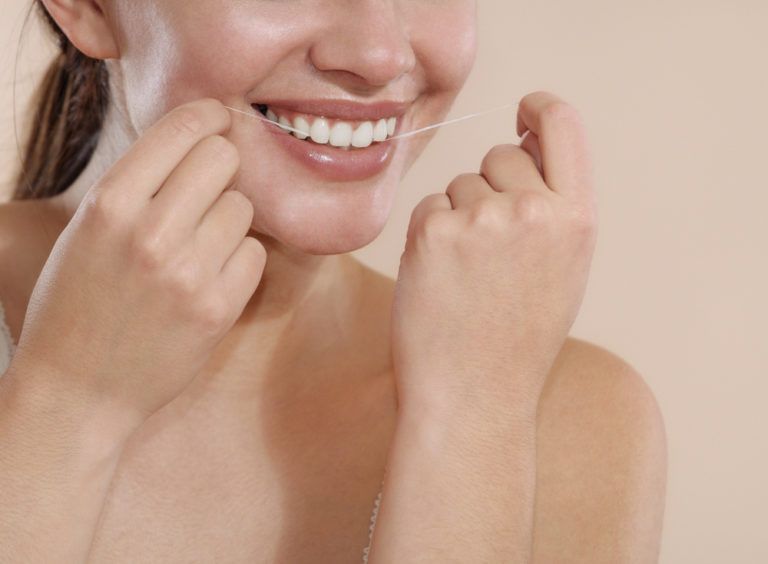 female teeth flossing