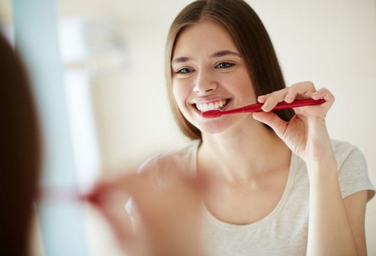 female brushing teeth