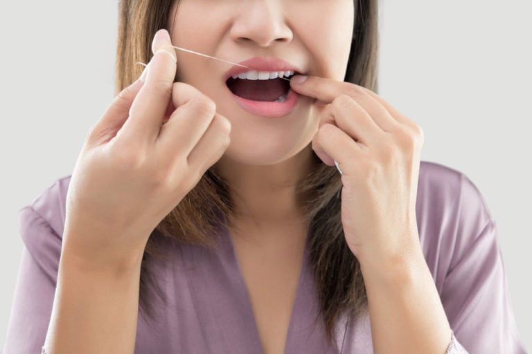 female flossing