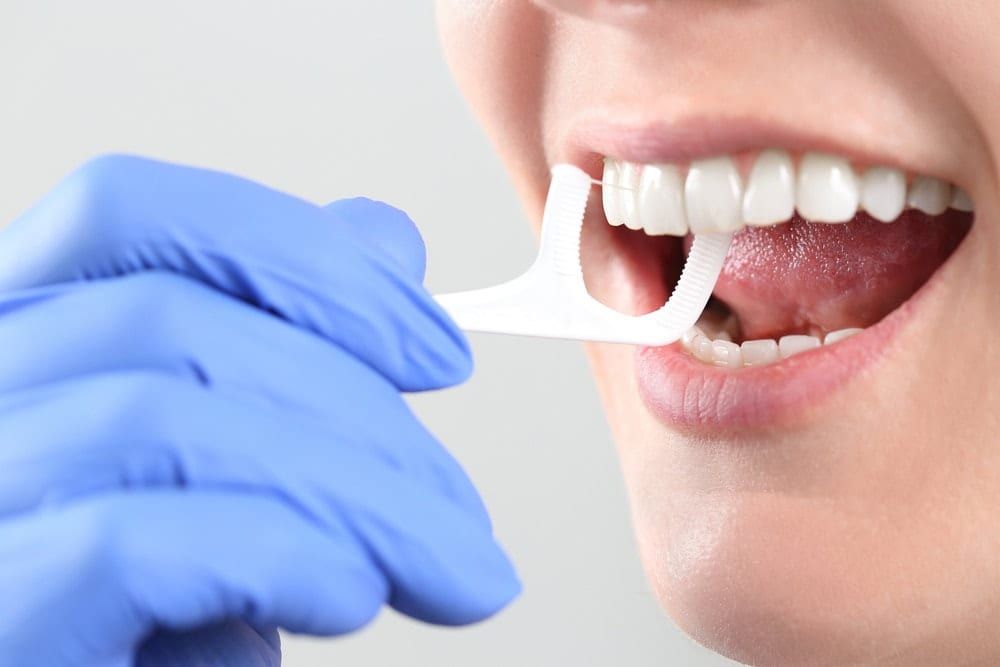female flossing