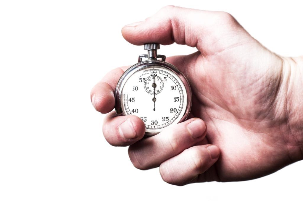 Male hand holding a stopwatch on a white background