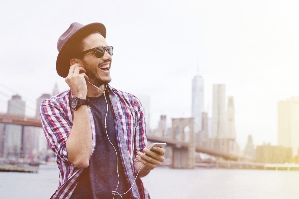 Man laughing with earphone