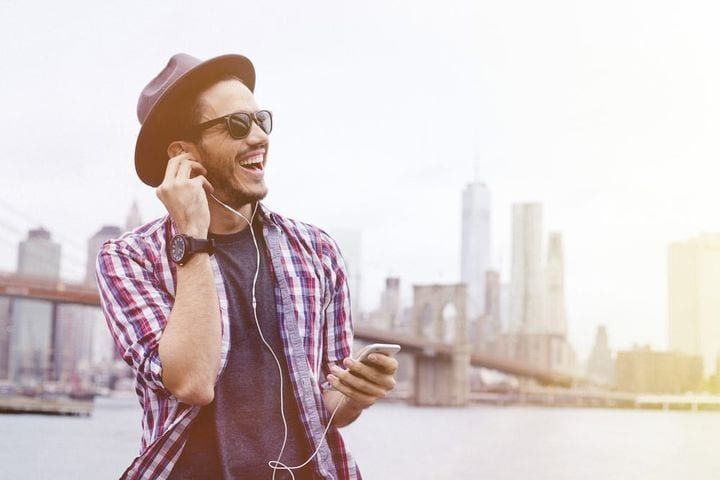 Man laughing with earphone