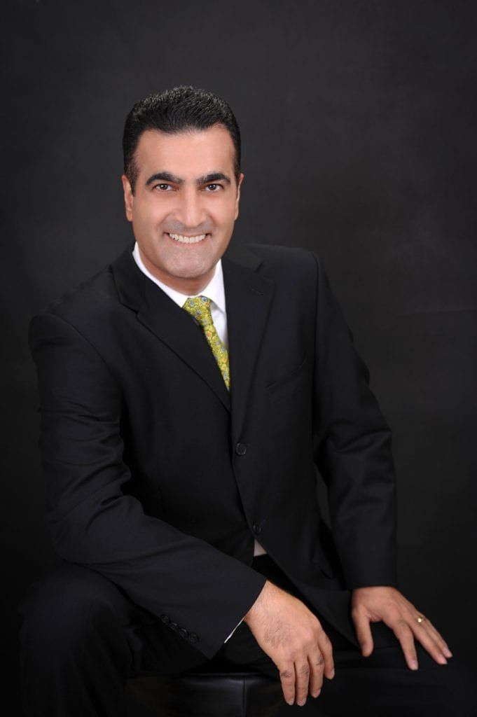 Dr. Sam Sadati wearing black suite portrait