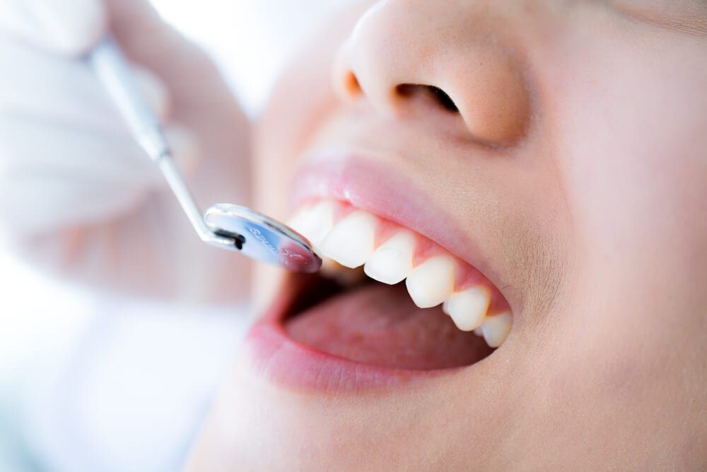 dental exam with instrument