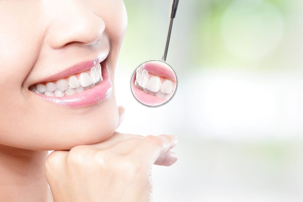 dental instrument examining smiling teeth
