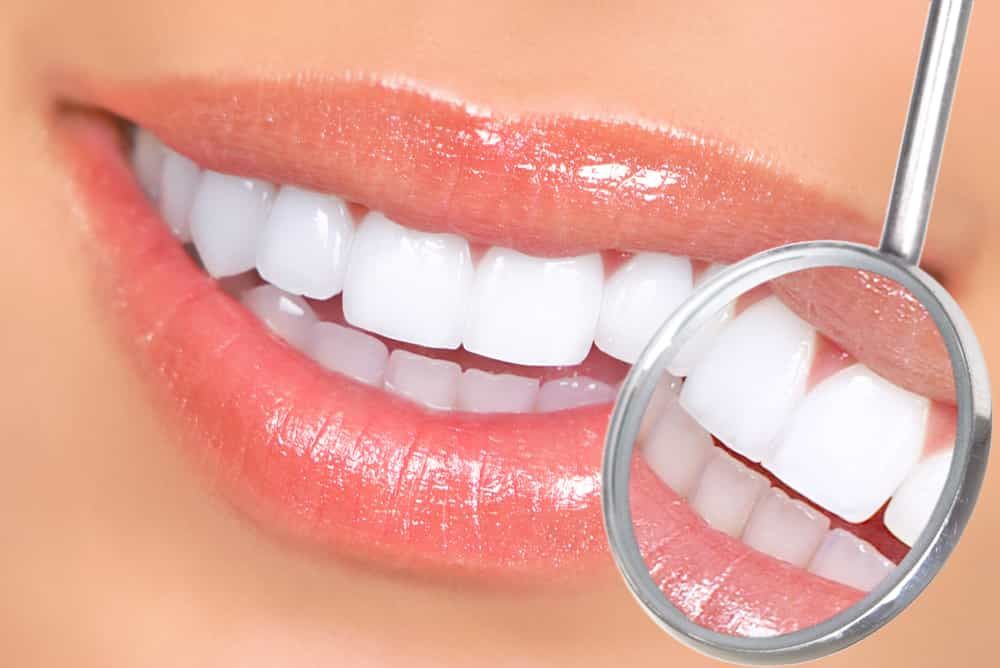 dental instrument examining white teeth