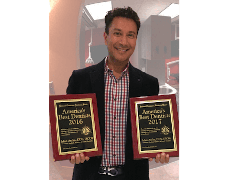 dr irfan atcha holding america's best dentist awards
