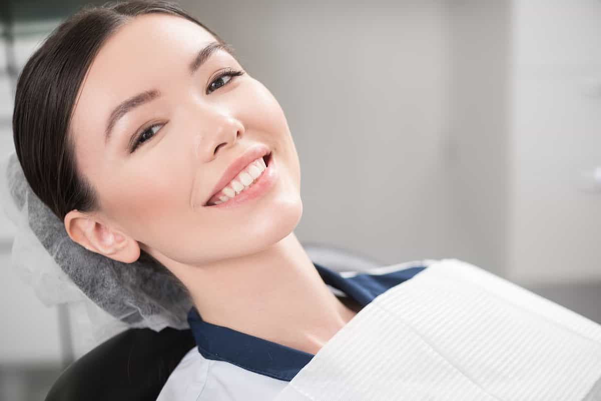 woman in dentist chair smiling