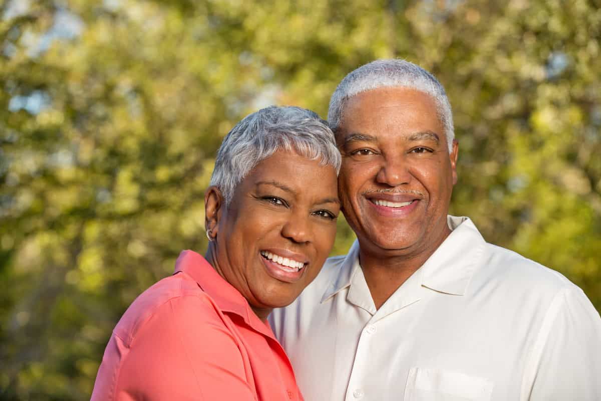 Man and woman smiling outside